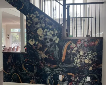 Staircase with mural of skulls and flowers on the wall