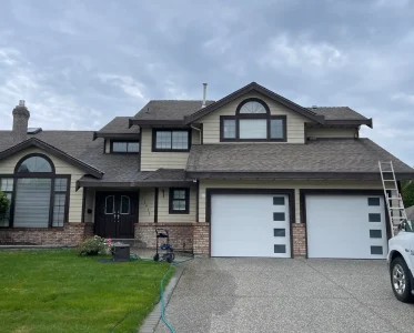 Large two-story white house with garage and front yard furniture