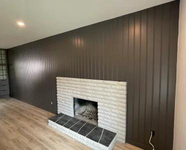 Cozy living room with white brick fireplace and comfortable seating